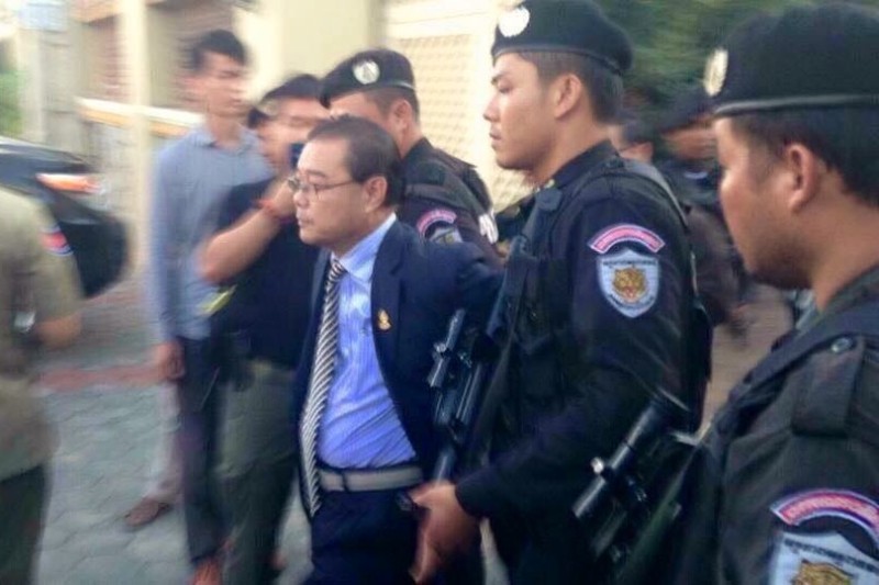 Opposition senator Hong Sok Hour is escorted into a police SUV outside a private residence in Phnom Penh's Sen Sok district, in a photograph posted the Facebook page of opposition leader Sam Rainsy.