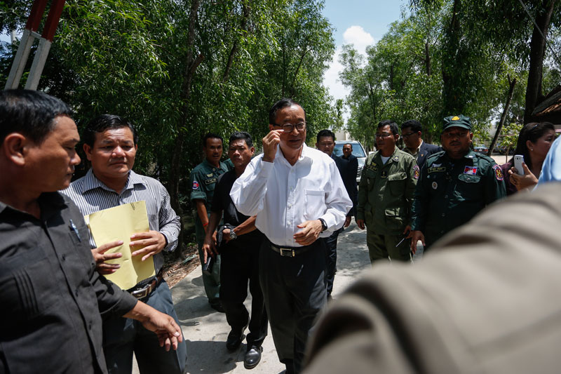 Opposition leader Sam Rainsy leaves Phnom Penh's Prey Sar prison on Monday. (Siv Channa/The Cambodia Daily)