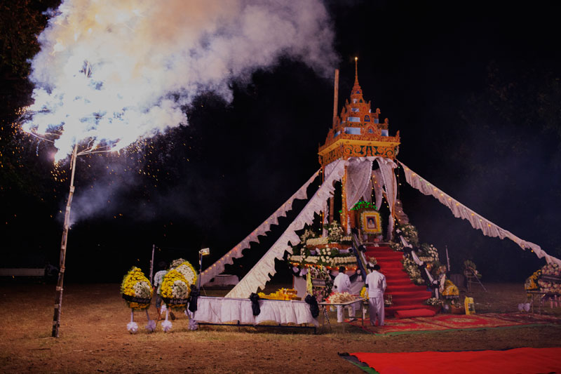 Fireworks are ignited next to Ieng Thirith's funeral pyre during her cremation ceremony in Pailin province on Monday night. (Jens Welding Ollgaard/The Cambodia Daily)