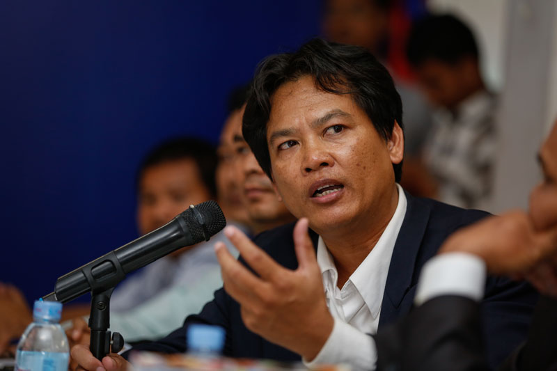 Royal Academy of Cambodia scholar Sok Touch speaks at the CNRP's headquarters in Phnom Penh on Monday, during a ceremony in which the opposition party handed over its border maps. (Siv Channa/ The Cambodia Daily)