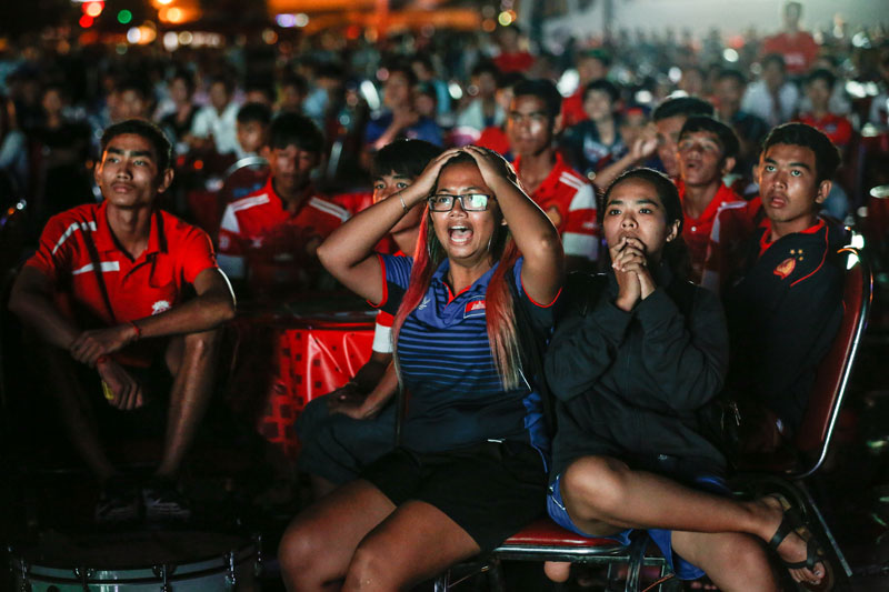 Fans watch Cambodia face off against Japan in a World Cup qualifier game Thursday night that was projected on a large screen on Phnom Penh's Koh Pich island. (Siv Channa/The Cambodia Daily)