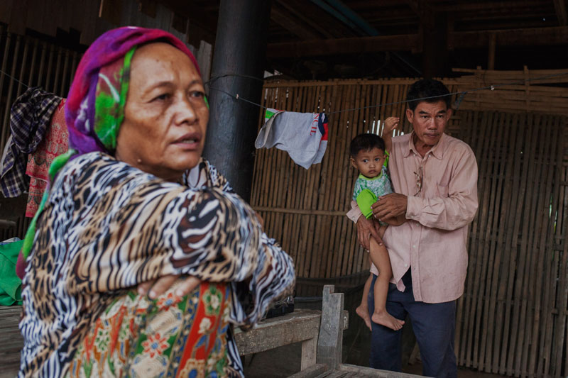 Svay Khleang village chief Slaiman Min holds his son at his house on Monday. (Jens Welding Ollgaard/The Cambodia Daily)