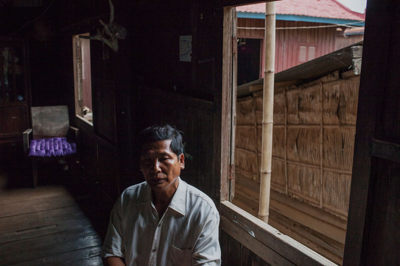 No Min sits inside his house. (Jens Welding Ollgaard/The Cambodia Daily)