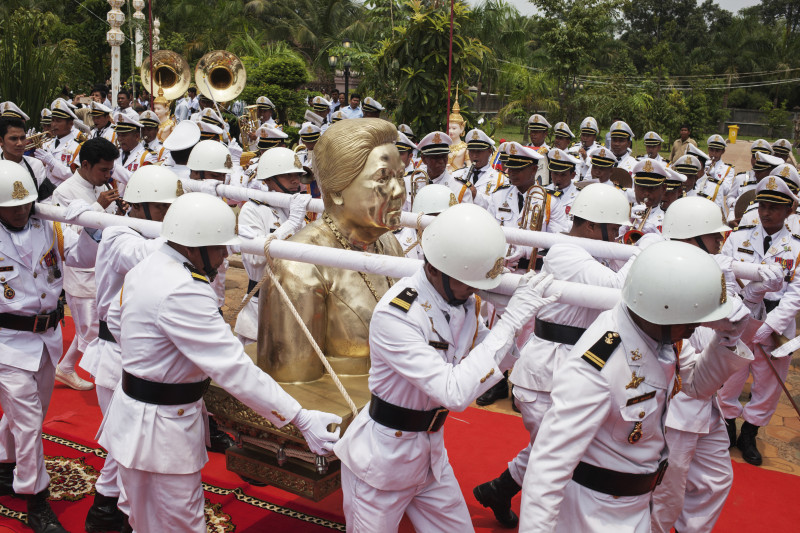 Military officers carry a golden bust of Nhem Soeun, the late wife of Chea Sim, to a purpose-built stupa on the family's estate in Prey Veng province during a ceremony on Friday. (Jens Welding Ollgaard/The Cambodia Daily)