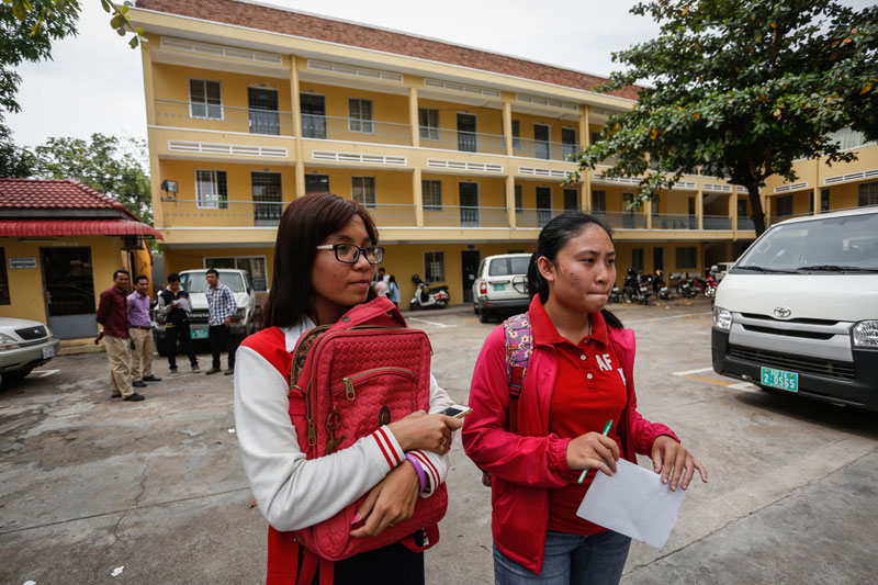 Students who took the national high school exam stand outside the Education Ministry in Phnom Penh, where they filed complaints over their grades Monday. (Siv Channa/The Cambodia Daily)
