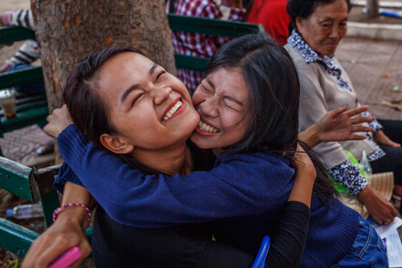 A student embraces a friend at Preah Sisowath High School in Phnom Penh on Saturday after learning that she passed the grade 12 national exam. (Jens Welding Ollgaard/The Cambodia Daily)