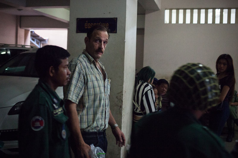 British businessman Gregg Fryett is escorted from the Phnom Penh Municipal Court on Wednesday. (Jens Welding Ollgaard/The Cambodia Daily)