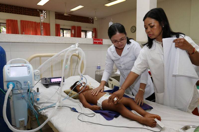A child receives medical care on Wednesday at the Kantha Bopha IV Children's Hospital in Phnom Penh. (Khem Sovannara)