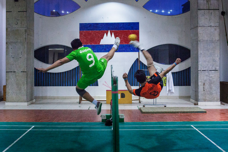 Two sepak takraw players face off during practice. (Jens Welding Ollgaard/The Cambodia Daily)