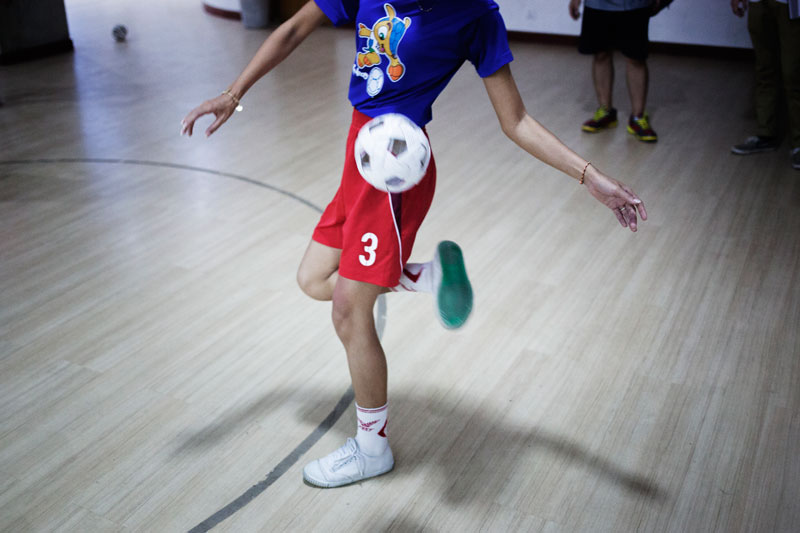 A woman juggles a sepak takraw ball during practice at the National Olympic Committee of Cambodia’s gymnasium in Phnom Penh earlier this month. (Jens Welding Ollgaard/The Cambodia Daily)