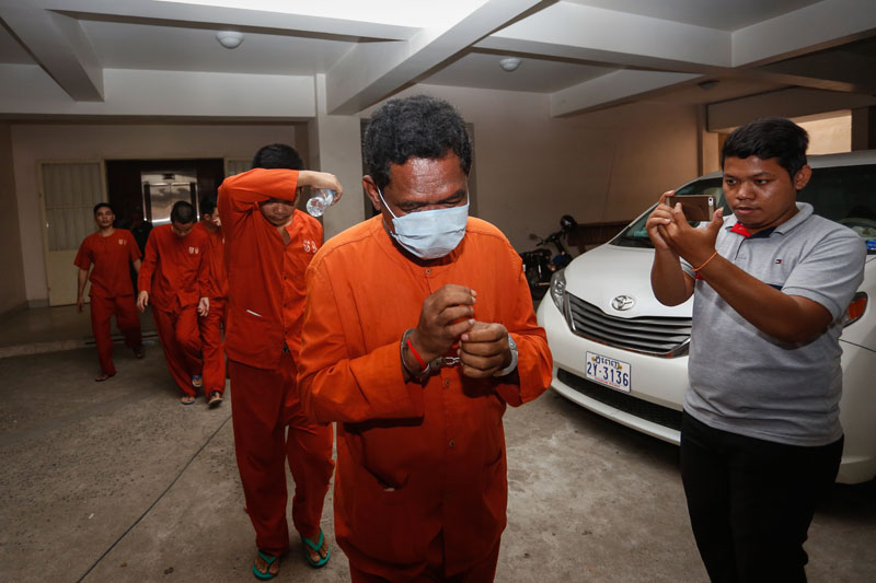 Tep Khuon leaves the Phnom Penh Municipal Court on Wednesday. (Siv Channa/The Cambodia Daily)