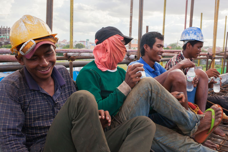 Workers take a break from construction on the One Park development project. (Jens Welding Ollgaard/The Cambodia Daily)