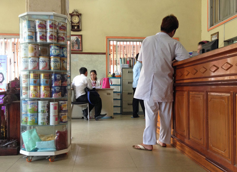 Baby formula is displayed in a Phnom Penh maternity clinic as health workers give advice to patients. (Matt Blomberg)