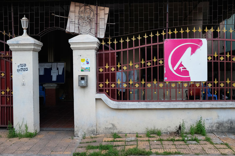 A decrepit sign for mobile operator Mfone hangs outside the defunct firm's office in Phnom Penh on Wednesday. (Jens Welding Ollgaard/The Cambodia Daily)