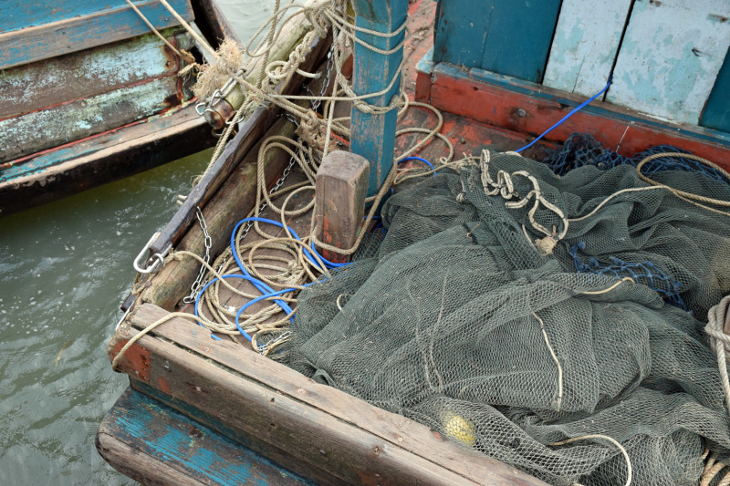 Blue electric cable is attached to trawling nets on a boat moored to the Prek Tanin pier. (Matt Blomberg) 