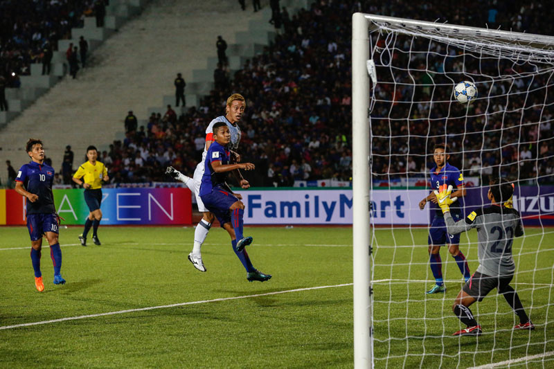 Japan's Keisuke Honda heads in his team's second goal against Cambodia at Olympic Stadium in Phnom Penh on Tuesday night. (Siv Channa/The Cambodia Daily)