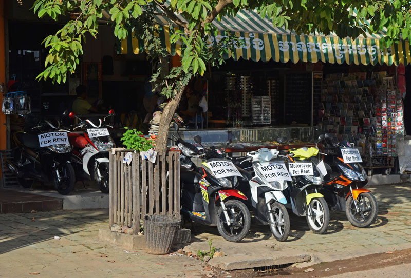 Signs advertise motorbikes for rent outside a souvenir shop in downtown Siem Reap on Sunday.