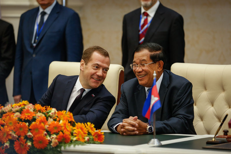 Prime Minister Hun Sen and his Russian counterpart, Dmitry Medvedev, share a laugh during a signing ceremony at Mr Hun Sen's office building in Phnom Penh on Tuesday. (Siv Channa/The Cambodia Daily)