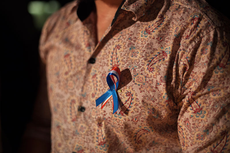 A man wears a French flag ribbon at the Institut Francais on Tuesday. (Jens Welding Ollgaard/The Cambodia Daily)