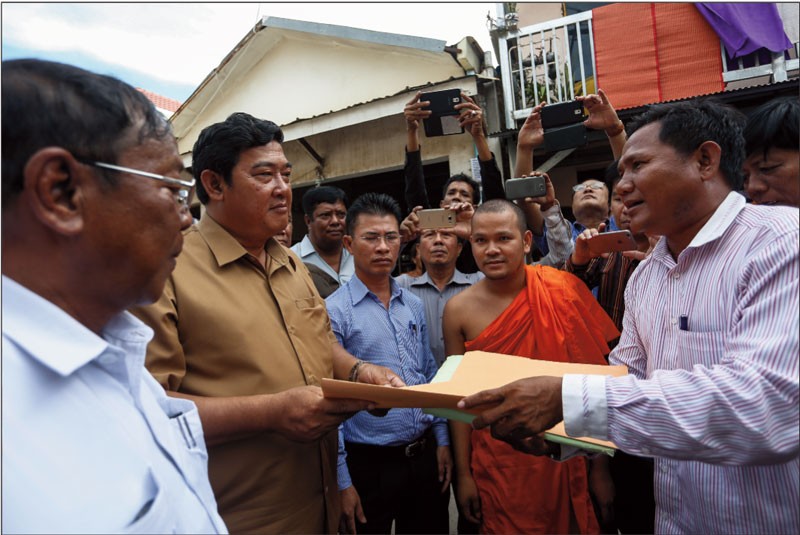 Villagers from Preah Vihear province hand over a petition to deputy Meanchey district governor Mea Sopheap in Phnom Penh on Thursday. (Siv Channa/The Cambodia Daily)