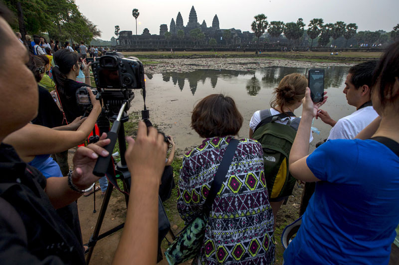 Tourists take photographs of Angkor Wat in 2015. (Reuters)