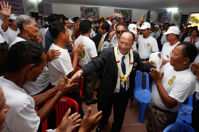 Mam Sonando greets members of his Beehive Social Democratic Party at their second congress in Phnom Penh on Saturday. (Siv Channa/The Cambodia Daily)