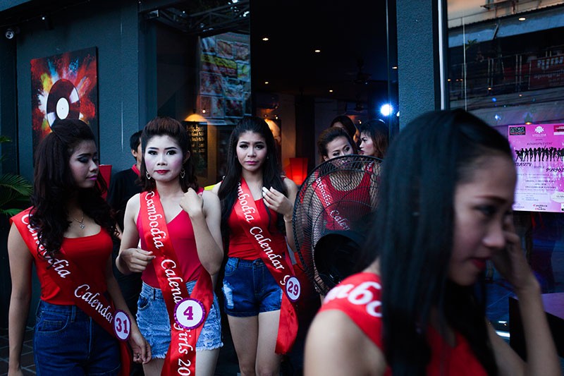 Participants in the 'Cambodia Calendar Girls' competition walk outside the Two Chefs Bar & Grill in Phnom Penh on Friday night. (Jens Welding Ollgaard/The Cambodia Daily)