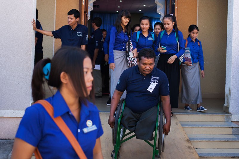 Attendees leave the National Institute for Education in Phnom Penh on Monday after an event to mark the Cambodian Day of Persons With Disabilities. (Jens Welding Ollgaard/The Cambodia Daily)