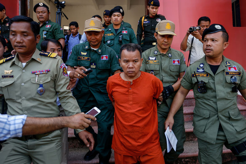 Yem Chrin is escorted out of the Battambang Provincial Court on Thursday after he was sentenced to 25 years in prison for causing an HIV outbreak in the province's Roka commune. (Siv Channa/The Cambodia Daily)
