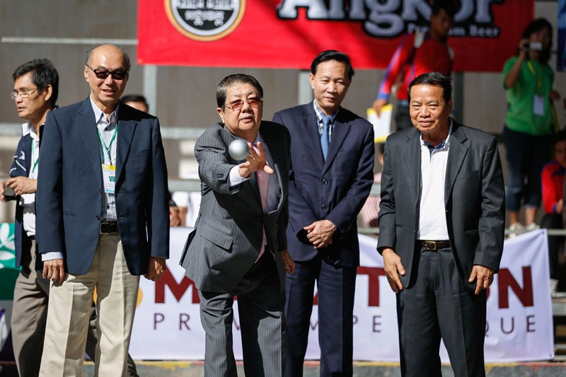 Deputy Prime Minister Sok An tosses a ball during the opening ceremony of the 19th Asian Petanque Championships at Olympic Stadium in Phnom Penh on Thursday. (Siv Channa/The Cambodia Daily)