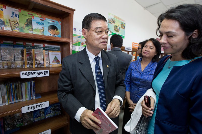 Labor Ministry Secretary of State Huy Han Song speaks with Ninel Ulloa Maureira, deputy director of the French Development Agency in Cambodia, during the inauguration of a library at the Japan Rocks factory in Phnom Penh on Tuesday. (Olivia Harlow/The Cambodia Daily)