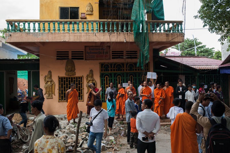 Kim Seila and his supporters gather on Tuesday in front of the house he purchased in Stung Meanchey pagoda. (Jens Welding Ollgaard/The Cambodia Daily)