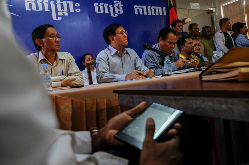 Deputy opposition leader Kem Sokha, flanked by opposition lawmakers Yim Sovann and Ho Vann, listens to a CNRP youth leader at the party's headquarters in Phnom Penh on Thursday. (Masayori Ishikawa)