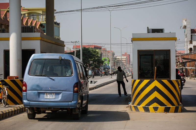 A van stops at a tollbooth at the entrance to Veng Sreng Boulevard in Phnom Penh on Monday.