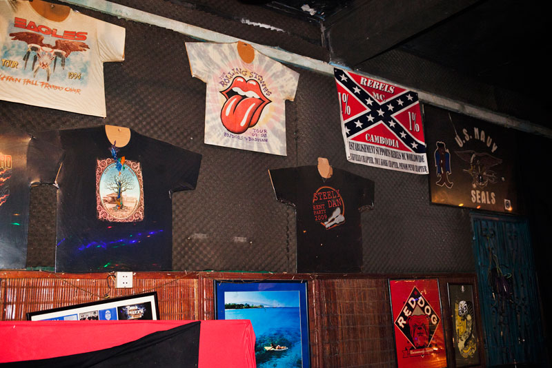 Band memorabilia and a Rebels Motorcycle Club flag hang on the wall at Sharky. (Jens Welding Ollgaard/The Cambodia Daily)