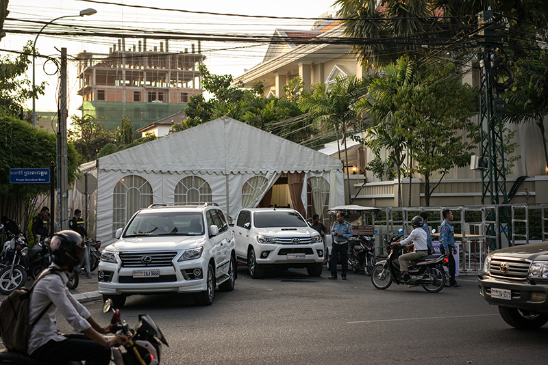 Police direct traffic in front of a wedding tent blocking Street 242 at the intersection of Norodom Boulevard in Phnom Penh on Friday. (Ben Woods/The Cambodia Daily)