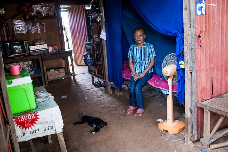 Seang Chanda speaks inside her house at the resettlement site in Phnom Bat commune. (Jens Welding Ollgaard/The Cambodia Daily)
