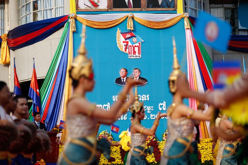 Apsara dancers perform during a ceremony at CPP headquarters in Phnom Penh on Thursday in front of a poster marking 37 years since the overthrow of the Khmer Rouge. (Siv Channa/The Cambodia Daily)