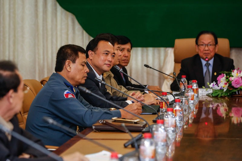 Royal Group chairman Kith Meng, third from left, listens during a meeting at the Land Management Ministry in Phnom Penh on Friday. (Siv Channa/The Cambodia Daily)