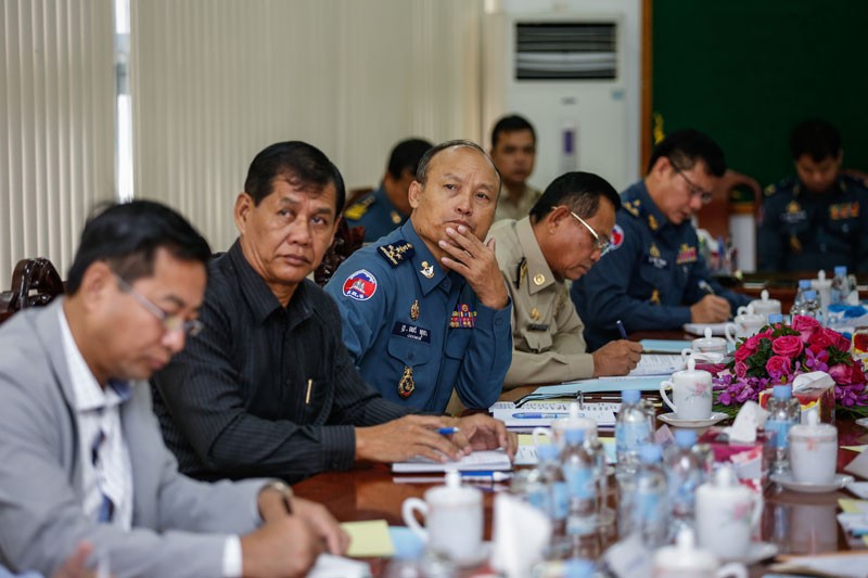 National Military Police Commander Sao Sokha, center, listens during a meeting of a new task force charged with combating illegal logging in eastern Cambodia, in Phnom Penh on Monday. (Siv Channa/The Cambodia Daily)