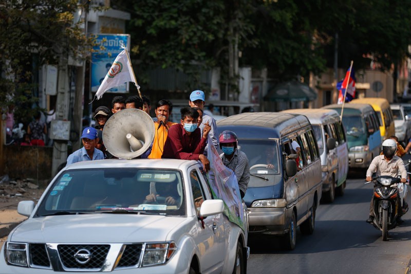 Garment workers drive through Phnom Penh on Thursday while delivering petitions in protest of the arrest of five union officials at a factory in Kompong Speu province on Tuesday. (Siv Channa/The Cambodia Daily)