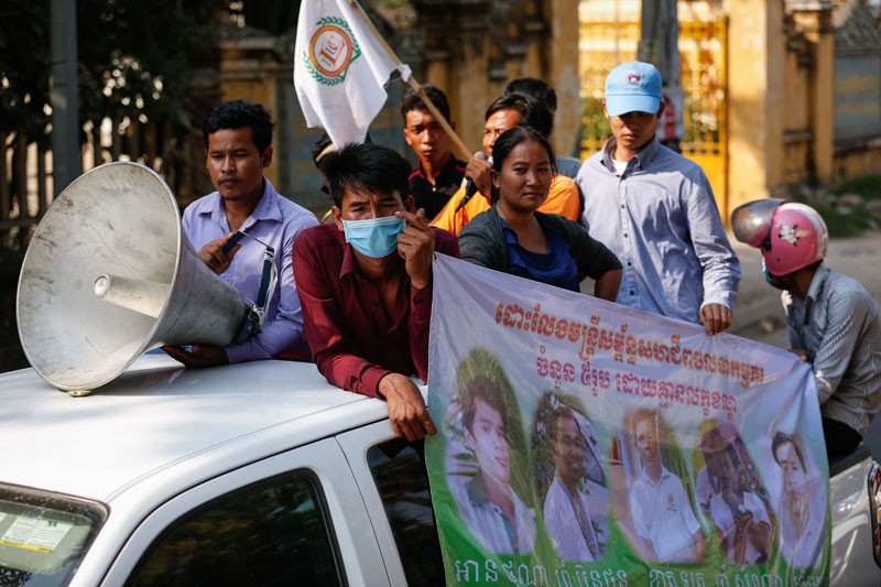 Garment workers drive through Phnom Penh yesterday while delivering petitions in protest of the arrest of five union officials at a factory in Kompong Speu province on Tuesday. (Siv Channa/The Cambodia Daily)