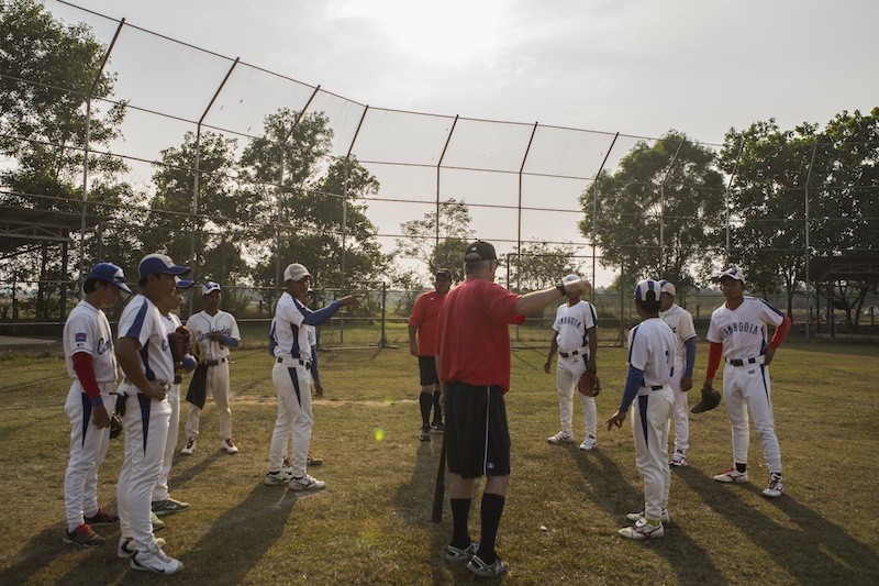 American coaches David Palese and Bill Thomas instruct Cambodia’s national baseball team during a practice in Kompong Thom province earlier this month. (Enric Catala)