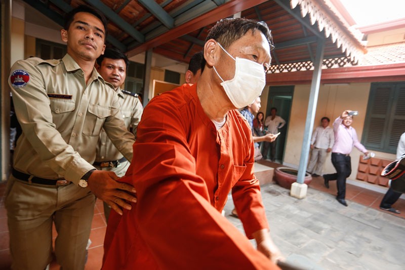 Former Phnom Penh Municipal Court director Ang Mealaktei is escorted into the Kandal Provincial Court in Takhmao City ahead of his sentencing on Friday. (Siv Channa/The Cambodia Daily) 