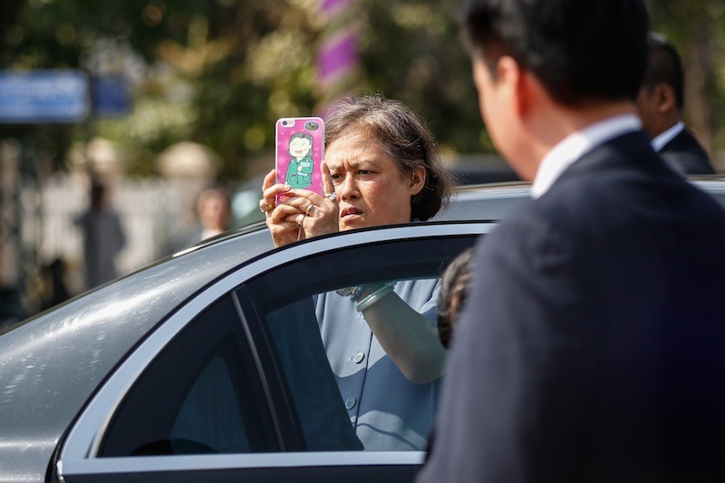 Thai Princess Maha Chakri Sirindhorn takes a photograph with her smartphone before paying her respects at the statue of late King Father Norodom Sihanouk in Phnom Penh on Tuesday. (Siv Channa/The Cambodia Daily)