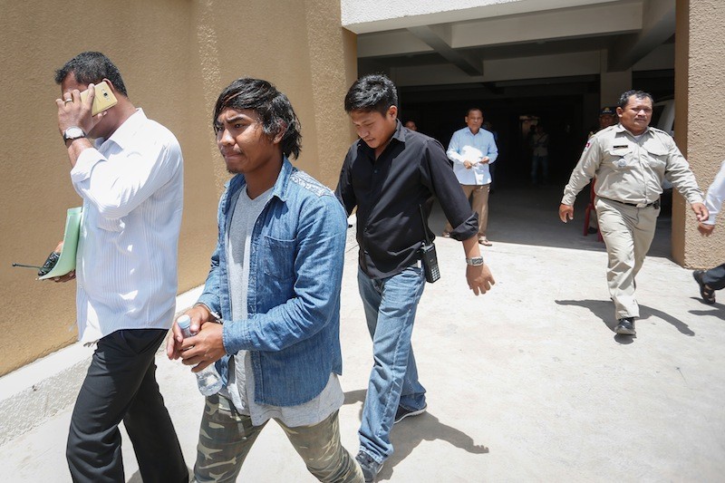 Phong Seiha is led away from the Phnom Penh Municipal Court in September after being charged with making a death threat on Facebook. (Siv Channa/The Cambodia Daily)
