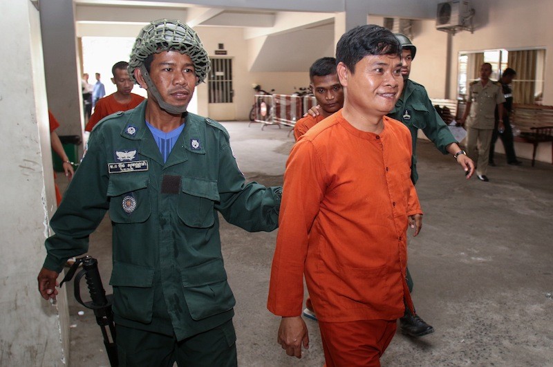 Hang Vibol is escorted into the Phnom Penh Municipal Court on Wednesday. (Khem Sovannara) 