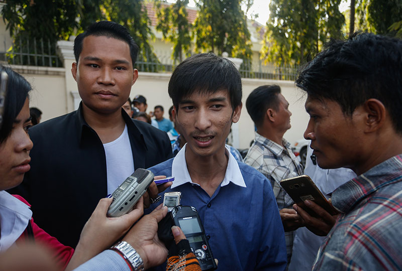 Student leader Srey Chamroeun, center, speaks to reporters outside the Anti-Corruption Unit's headquarters in Phnom Penh on Friday. (Siv Channa/The Cambodia Daily)