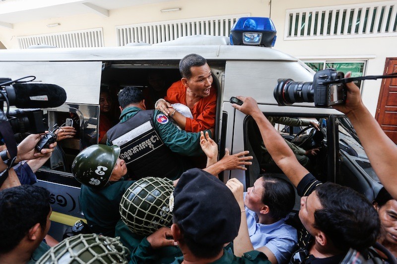 Opposition official Meach Sovannara shouts as he is pushed into a police van following an Appeal Court hearing in Phnom Penh on Thursday for 11 CNRP activists convicted of insurrection. (Siv Channa/The Cambodia Daily)