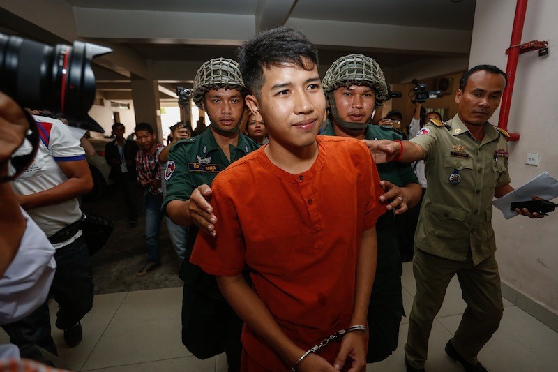 Kong Raya is escorted into the Phnom Penh Municipal Court on Tuesday. (Siv Channa/The Cambodia Daily)